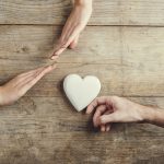 Man offering a heart to a woman.