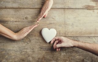 Man offering a heart to a woman.