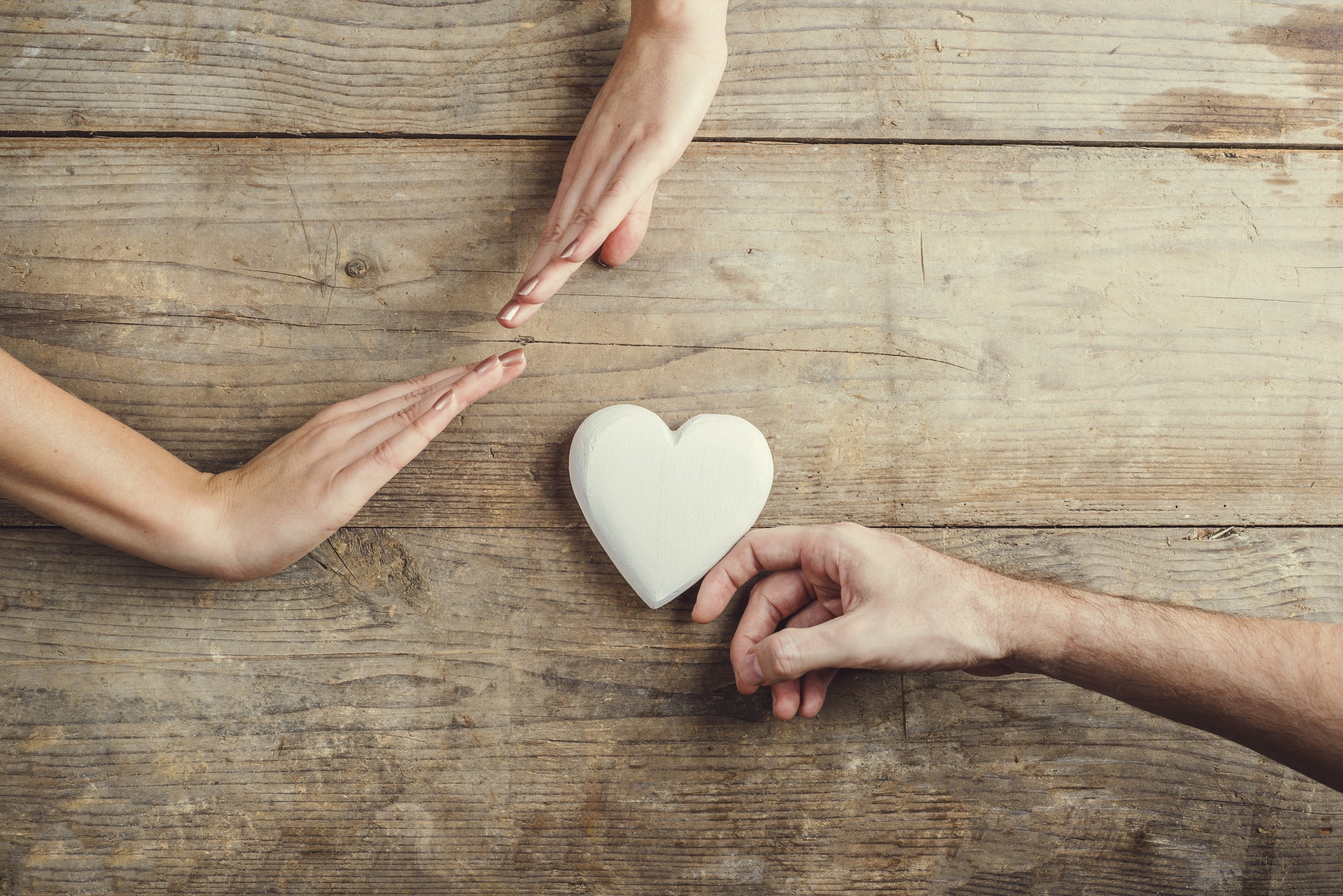 Man offering a heart to a woman.