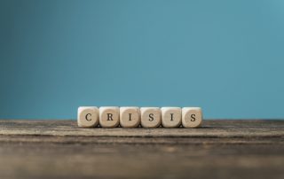 Word Crisis spelled on wooden dices