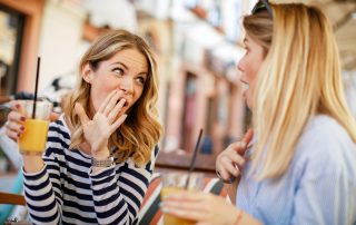 Two women gossiping in a cafe